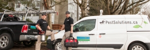 vanncouver monthly pest control service technicians with their trucks outside large condo building